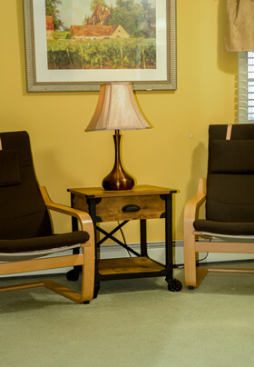 table lamp flanked by brown chairs