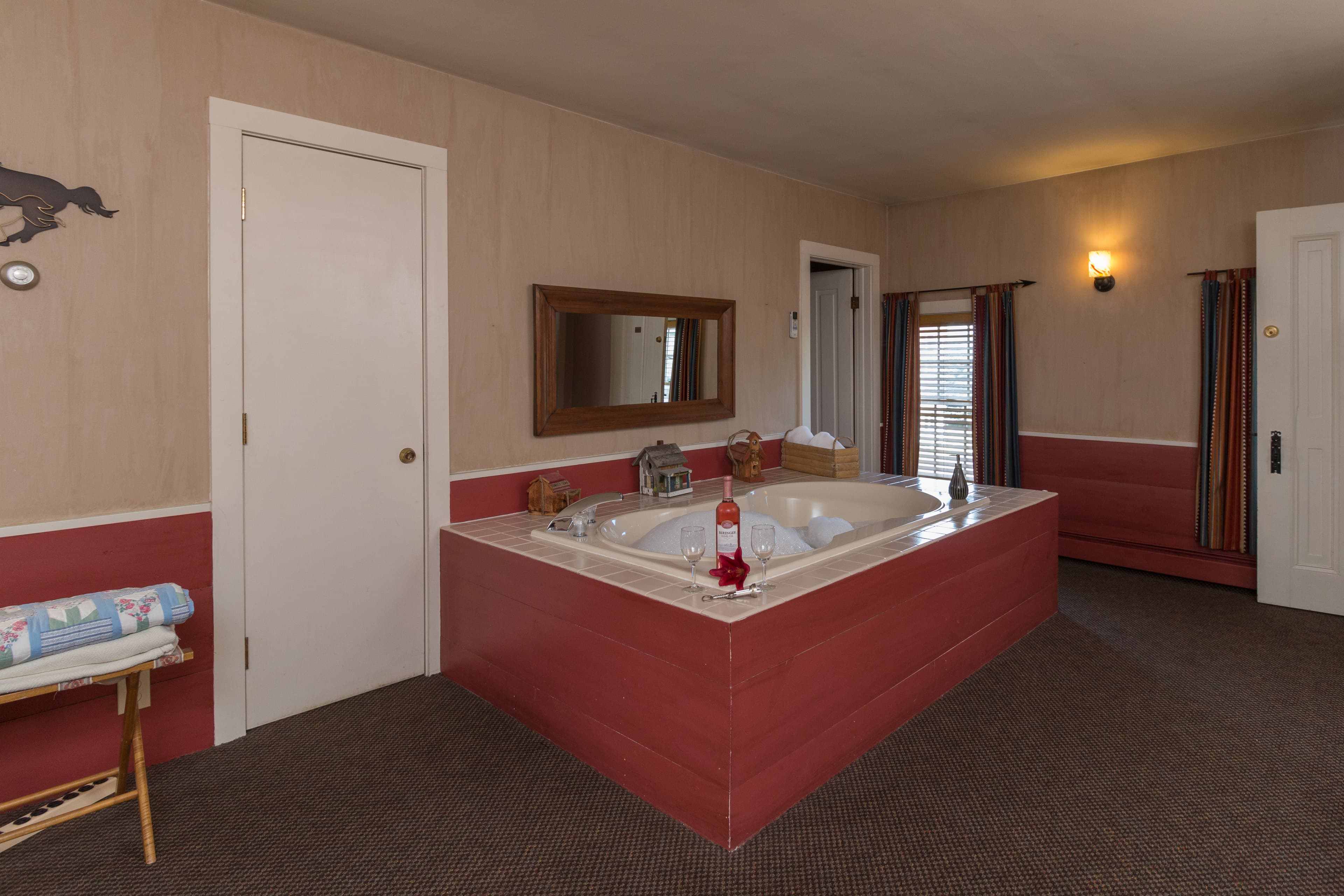 Big free-standing Jacuzzi tub flanked by white doors