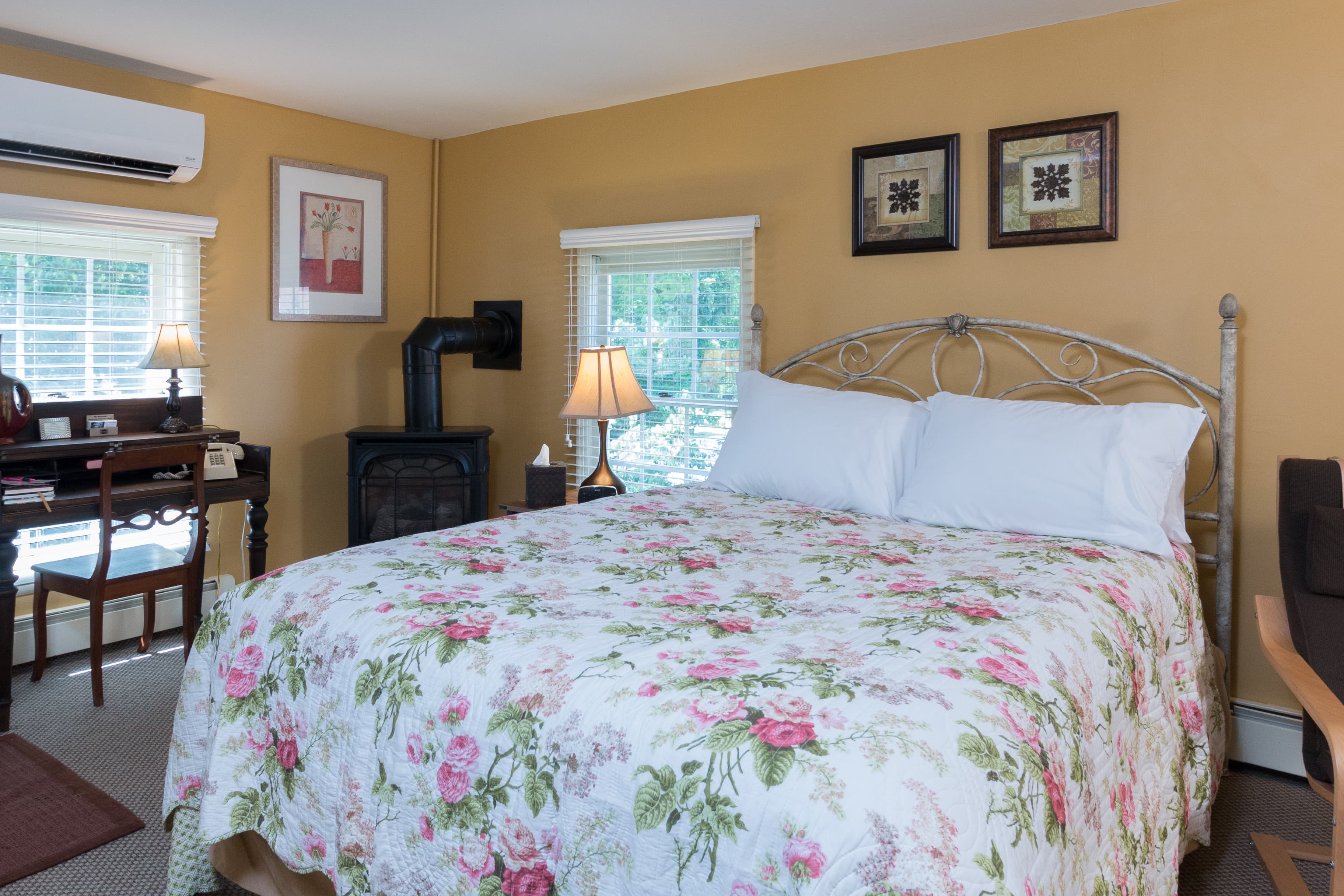 Floral quilted bedspread in yellow room