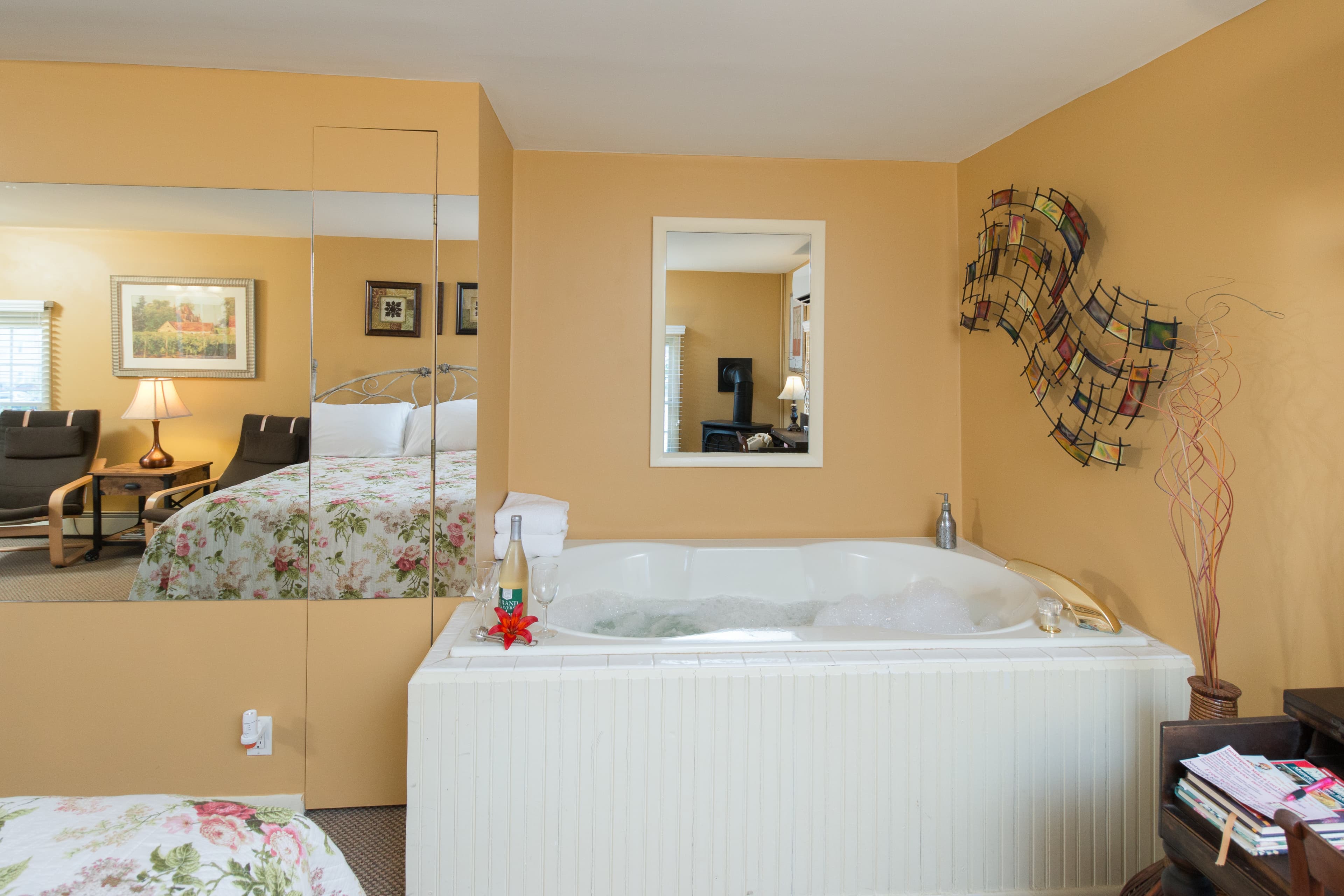 Free standing Jacuzzi tub in room with yellow walls
