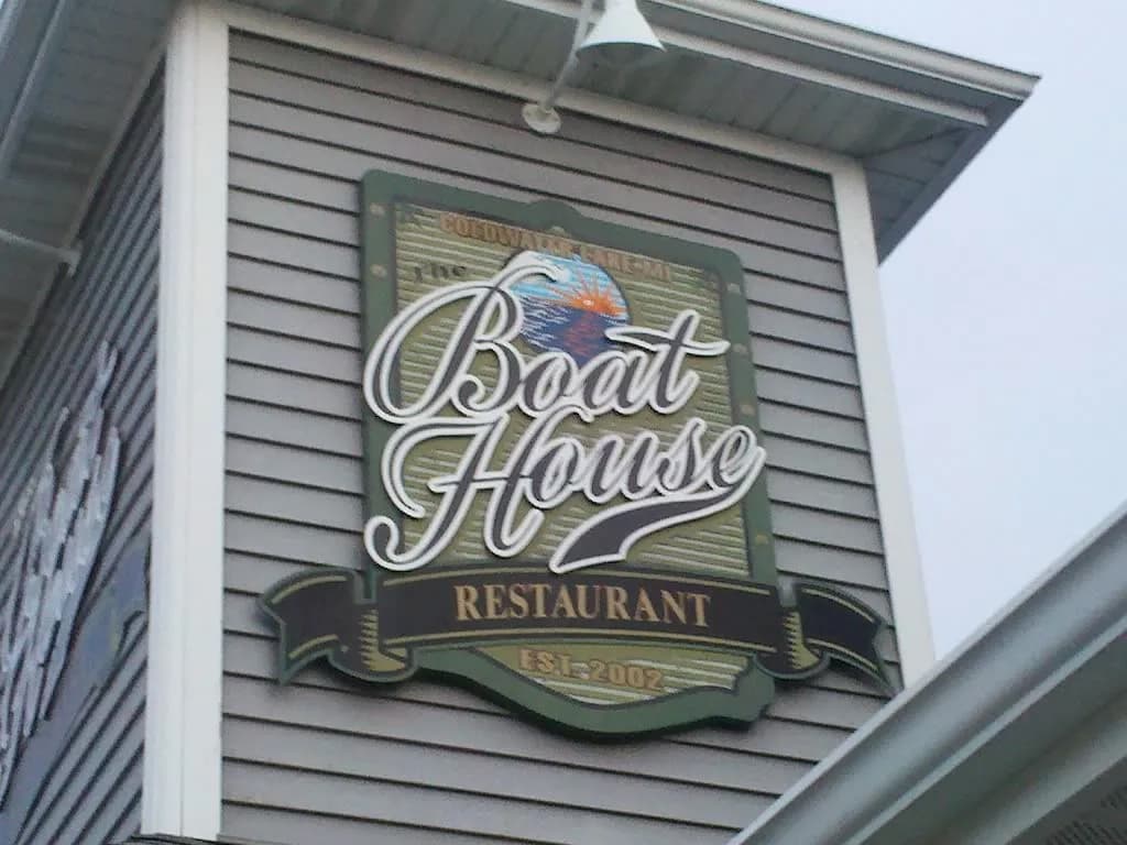 Sign for "The Boat House Restaurant," featuring a colorful bird design.