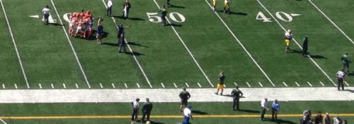 green football field with white lines and numerals