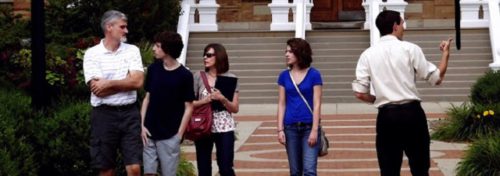 students and parents on a brick paved sidewalk