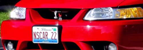 shiny red car with NSCAR22 license plate