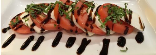 red tomato salad with white mozzarella cheese and balsamic vinegar